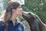 Community college student intern receiving a sea lion kiss